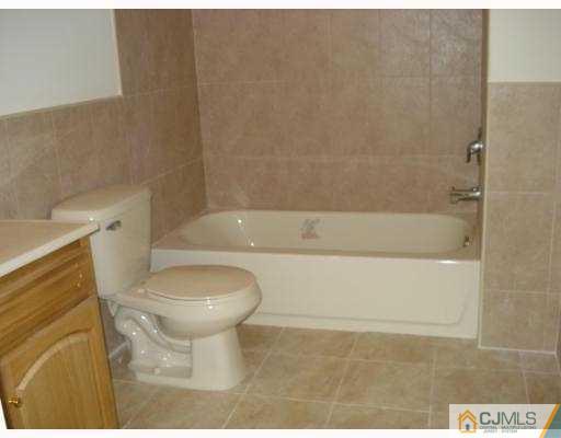 10 Edwin Street Carteret, NJ 07008 - Photo 6 of 10 a bathroom with a sink a toilet and bathtub