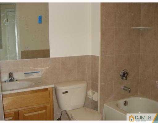 10 Edwin Street Carteret, NJ 07008 - Photo 8 of 10 a bathroom with a bathtub and a sink