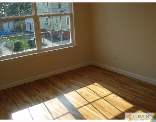 10 Edwin Street Carteret, NJ 07008 - Photo 9 of 10 a view of empty room with wooden floor and fan