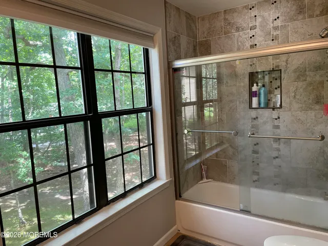 a bathroom with a bathtub and a shower