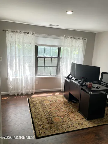 a living room with furniture rug and a window