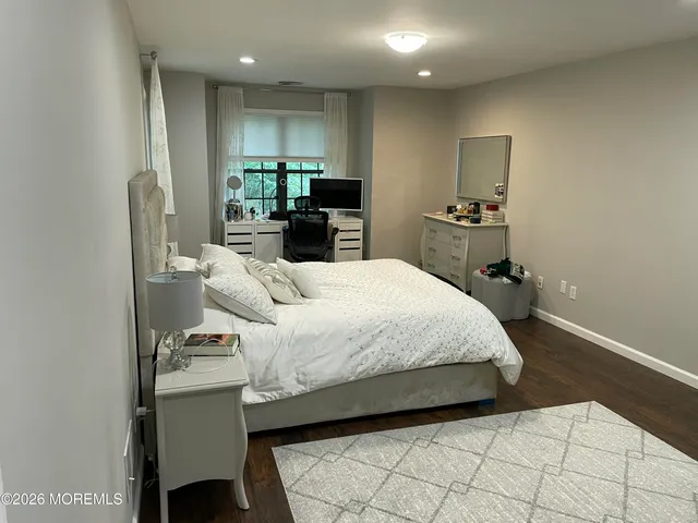 a spacious bedroom with a bed and a view of bathroom