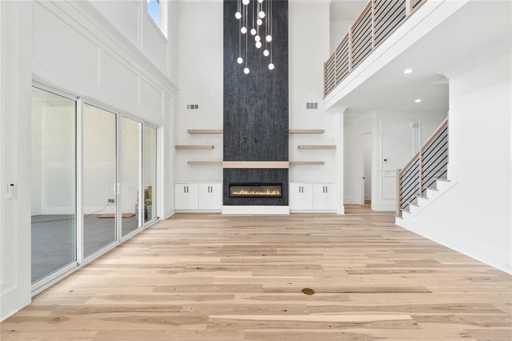 876 Bramlett Shoals Road Lawrenceville, GA 30045 - Photo 11 of 64 a view of an empty room with wooden floor and staircase