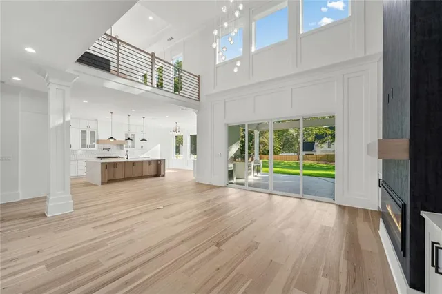 a view of a kitchen with kitchen island a sink stainless steel appliances and cabinets