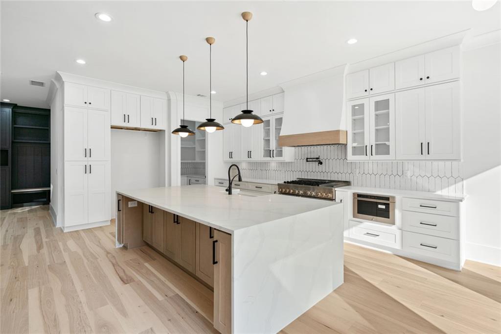 876 Bramlett Shoals Road Lawrenceville, GA 30045 - Photo 16 of 64 a kitchen with stainless steel appliances kitchen island granite countertop a sink a stove and a refrigerator