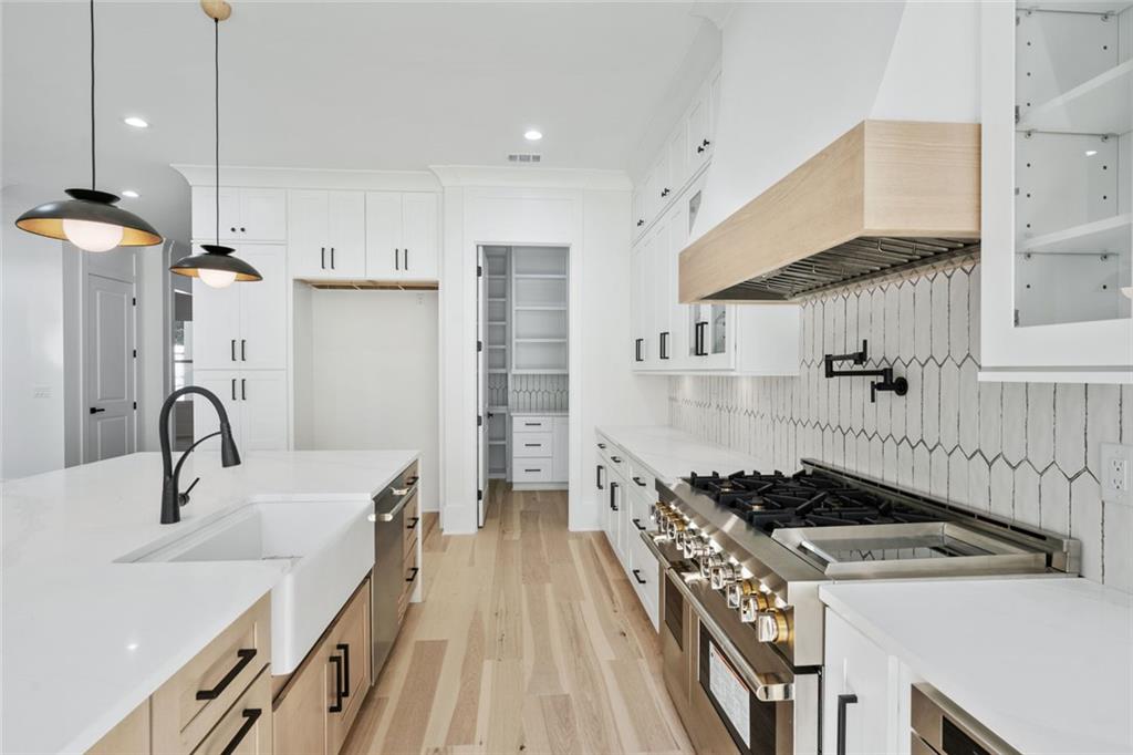 876 Bramlett Shoals Road Lawrenceville, GA 30045 - Photo 18 of 64 a kitchen with a stove and a sink