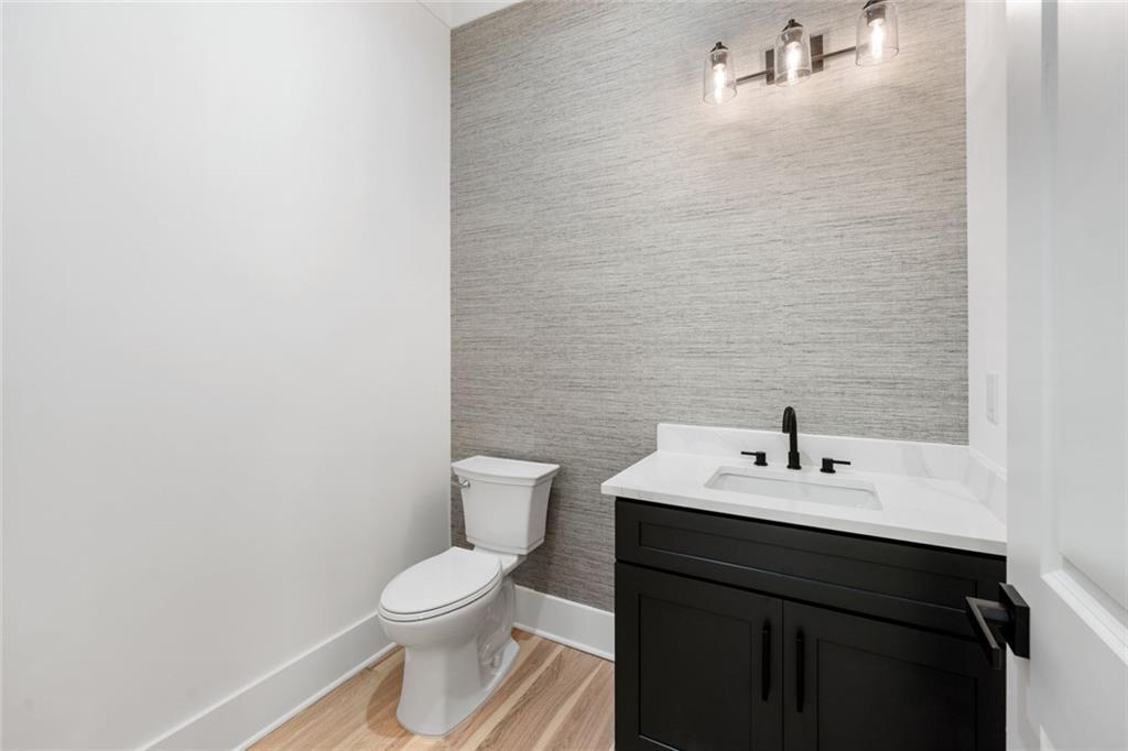 876 Bramlett Shoals Road Lawrenceville, GA 30045 - Photo 23 of 64 a bathroom with a sink a toilet and mirror