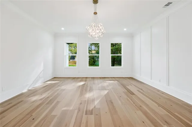 a view of a living room and kitchen with wooden floor