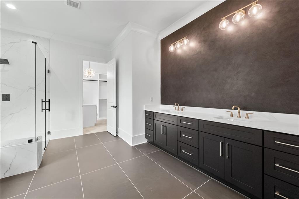 876 Bramlett Shoals Road Lawrenceville, GA 30045 - Photo 26 of 64 a spacious bathroom with a double vanity sink a mirror and a shower