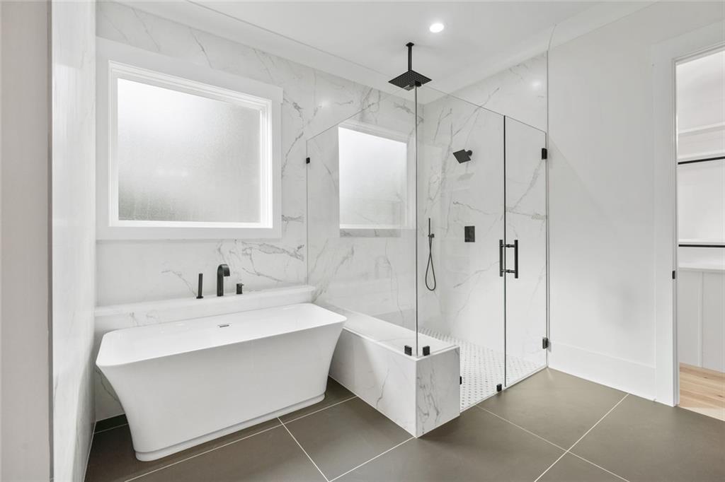 876 Bramlett Shoals Road Lawrenceville, GA 30045 - Photo 27 of 64 a bathroom with a sink a mirror and a bathtub