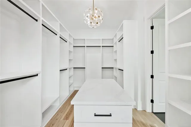 a view of large kitchen with refrigerator sink and cabinets
