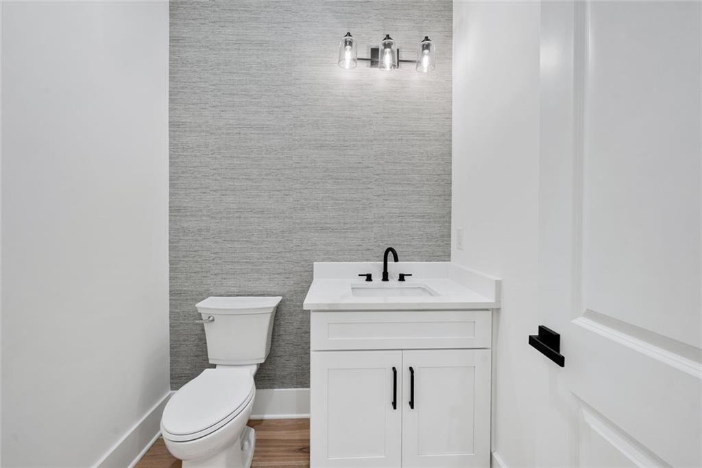 876 Bramlett Shoals Road Lawrenceville, GA 30045 - Photo 36 of 64 a white toilet sitting next to a bathroom sink