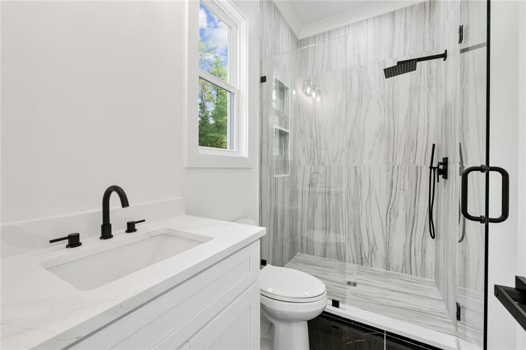 876 Bramlett Shoals Road Lawrenceville, GA 30045 - Photo 39 of 64 a bathroom with a sink a toilet and shower