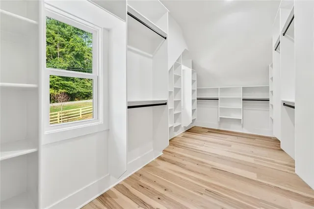 a view of an empty room with a fireplace and a window