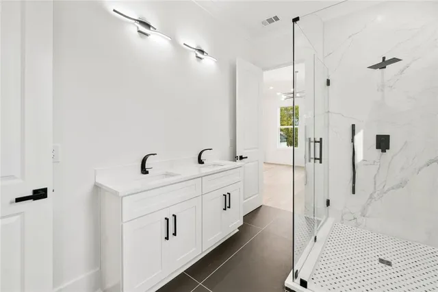 a front view of house with yard and trees in the background