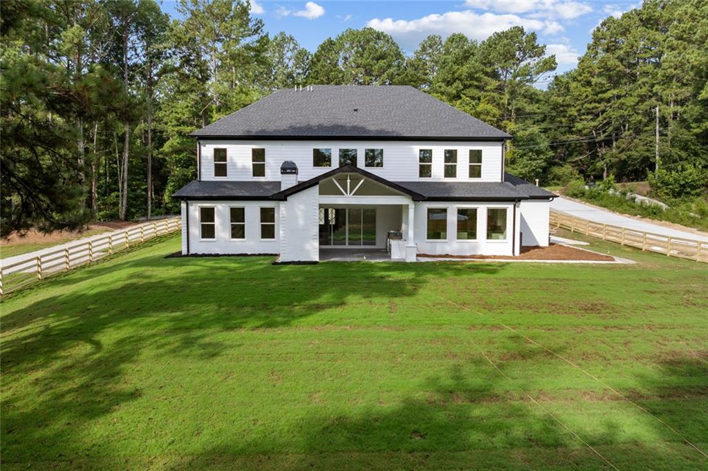 876 Bramlett Shoals Road Lawrenceville, GA 30045 - Photo 56 of 64 a front view of a house with a garden