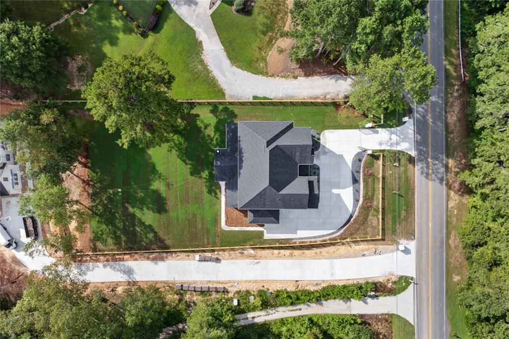 876 Bramlett Shoals Road Lawrenceville, GA 30045 - Photo 62 of 64 an aerial view of a house with swimming pool and large trees