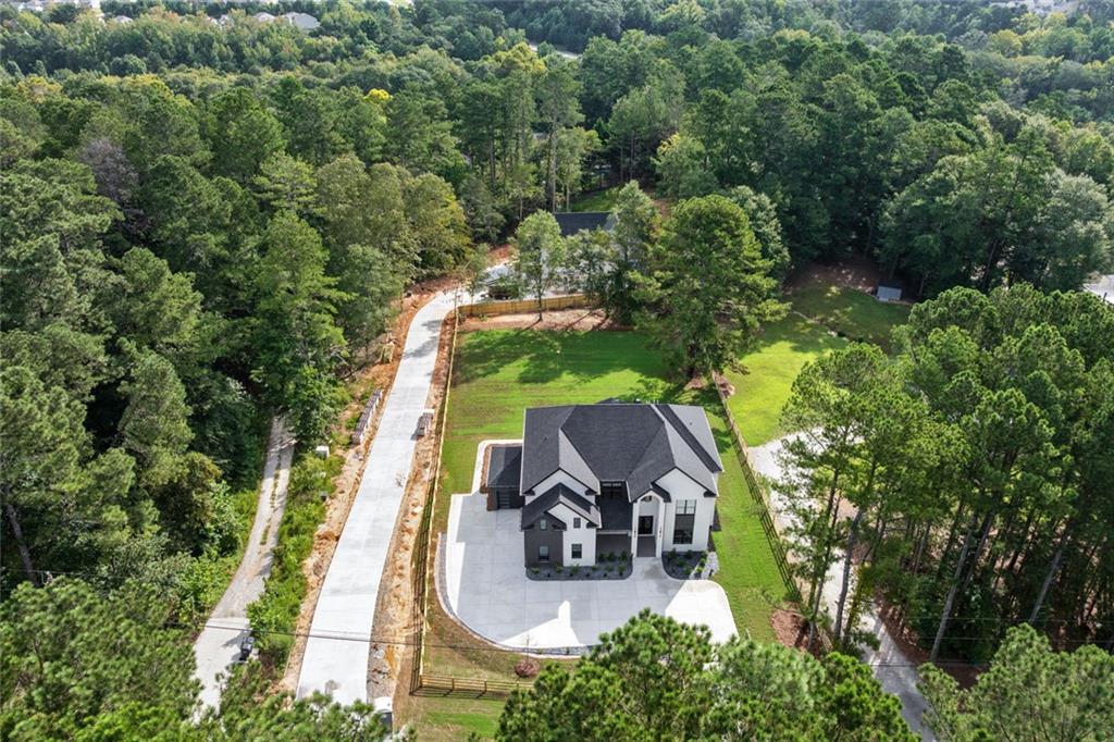 876 Bramlett Shoals Road Lawrenceville, GA 30045 - Photo 64 of 64 an aerial view of a house with swimming pool and garden