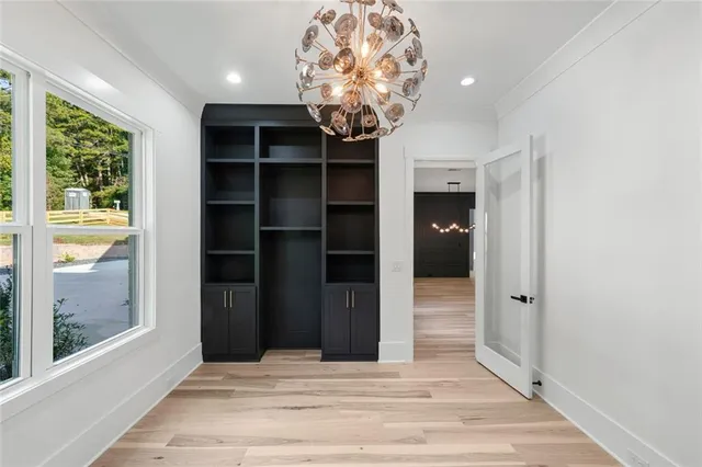 a view of kitchen with refrigerator and wooden floor