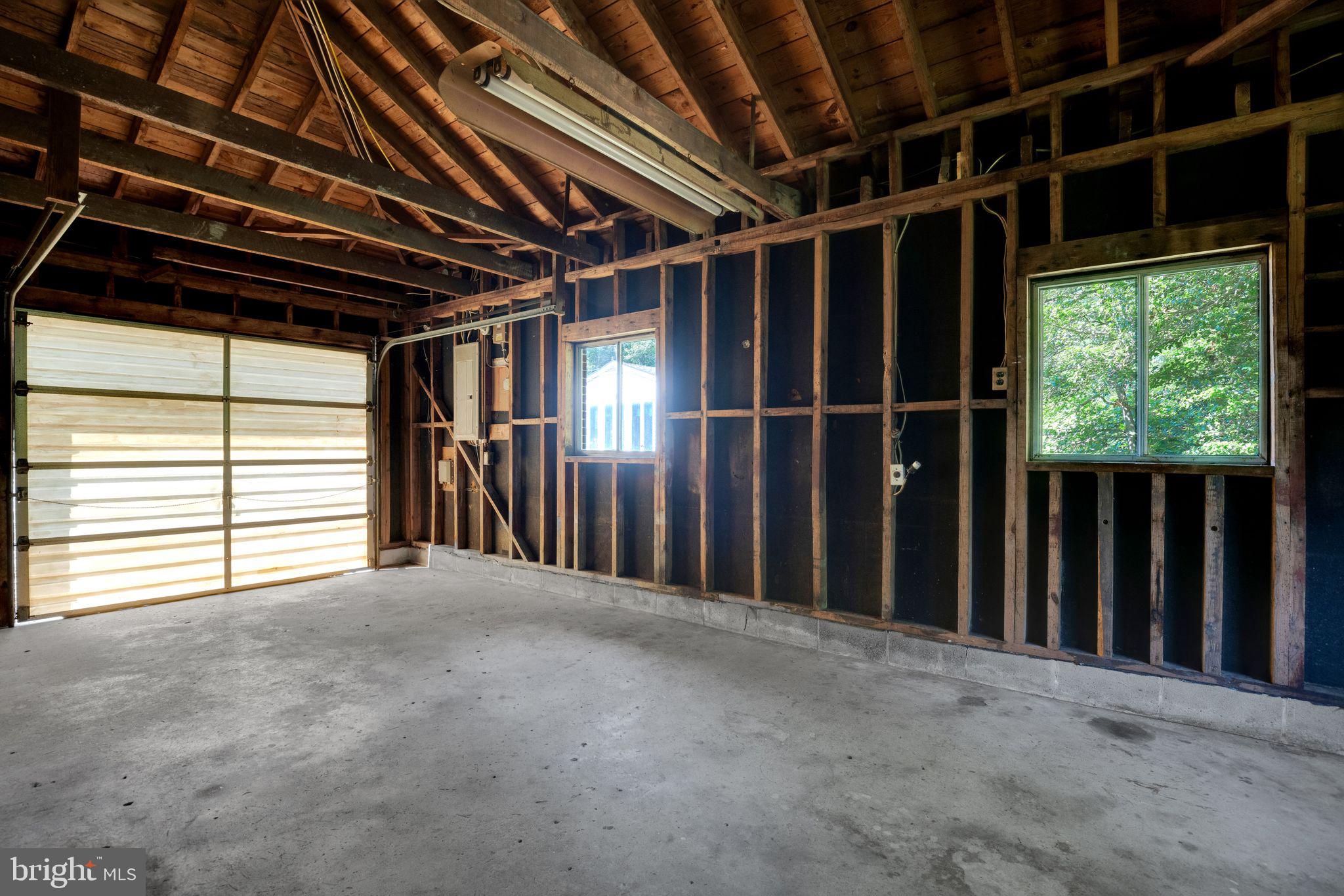 45382 Sypher Road California, MD 20619 - Photo 29 of 58 Garage with workshop space & wood stove
