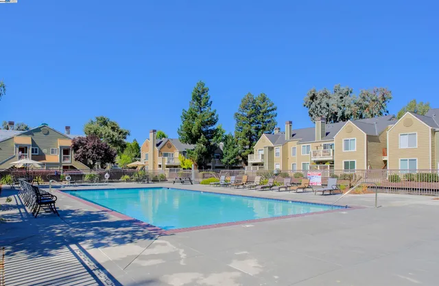 a view of multiple houses with a swimming pool