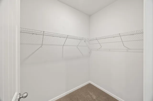 a view of a big room with wooden floor and a bathroom