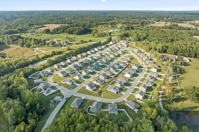 an aerial view of residential houses with outdoor space
