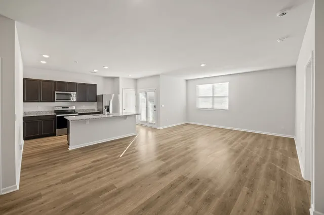 a view of kitchen with refrigerator sink and stove