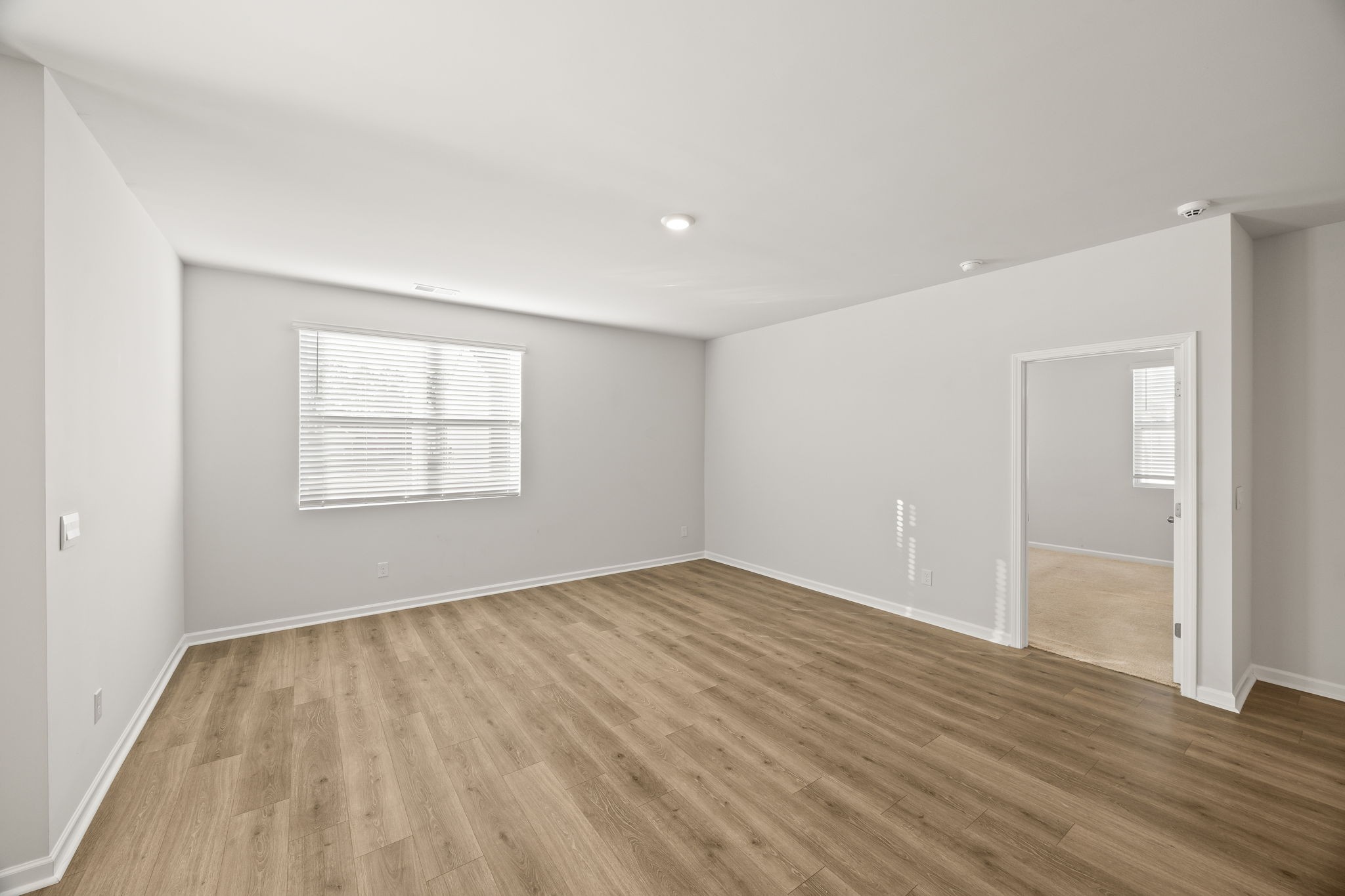 312 Oliver Way Baxter, TN 38544 - Photo 7 of 33 an empty room with wooden floor and windows