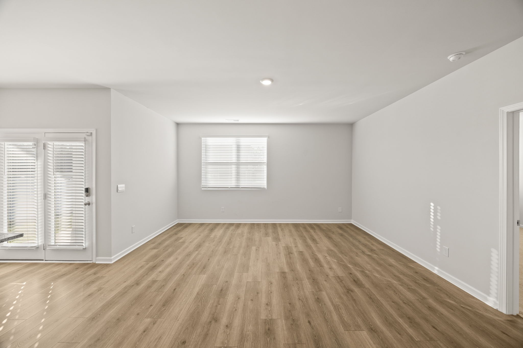312 Oliver Way Baxter, TN 38544 - Photo 8 of 33 an empty room with wooden floor and windows