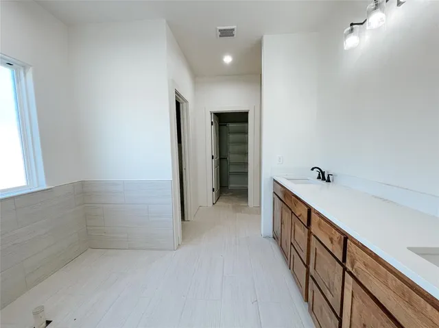 a view of hallway with stairs and wooden floor