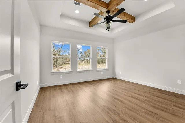 a view of a room with wooden floor and white walls