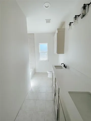 a bathroom with a sink a toilet and mirror