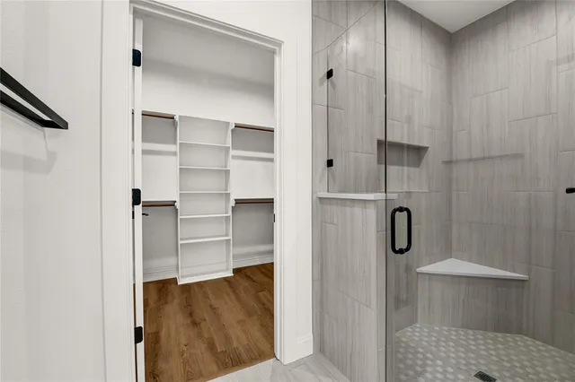 a view of walk in closet with empty racks