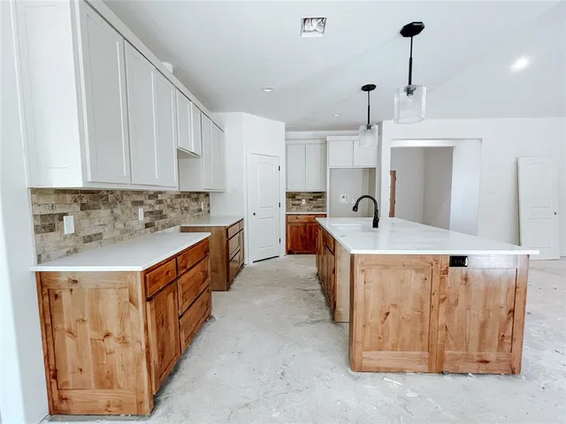 a kitchen with stainless steel appliances a sink stove and cabinets