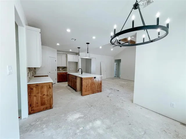 a kitchen with stainless steel appliances granite countertop a stove a refrigerator a oven a sink a island and a refrigerator