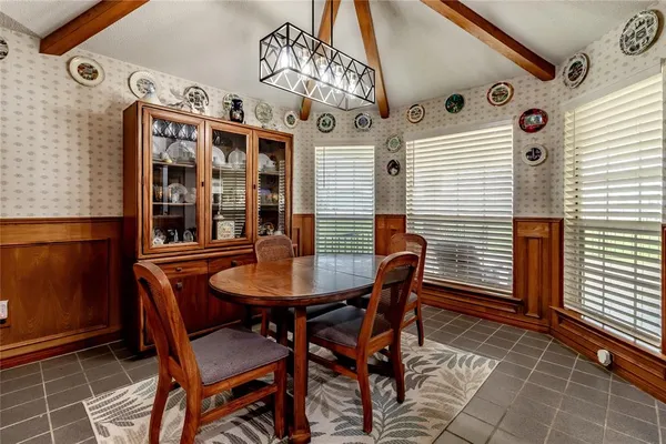 a view of a dining room with furniture and window