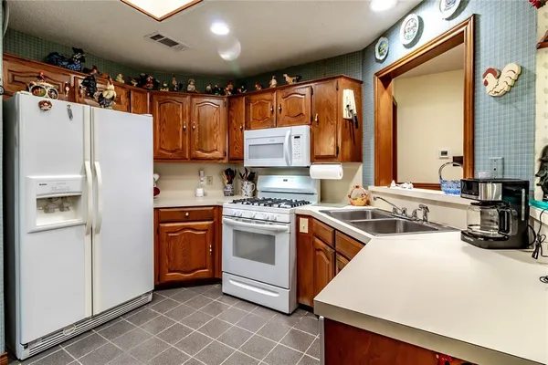 a view of a storage & utility room with a fridge