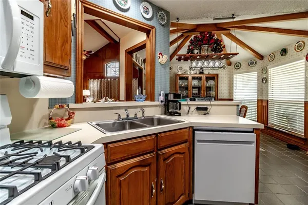 a kitchen with a stove top oven sink and cabinets