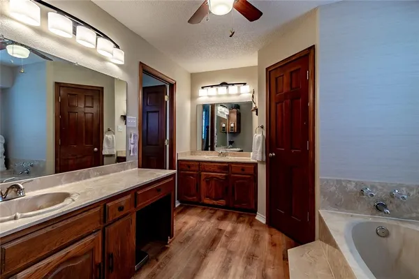 a spacious bedroom with a bed and a chandelier