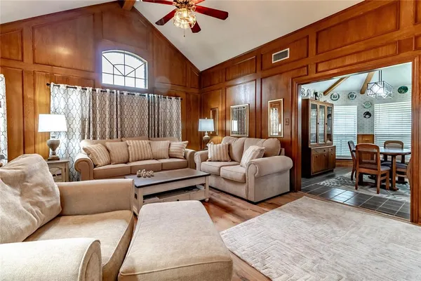 a living room with furniture fireplace and a large window