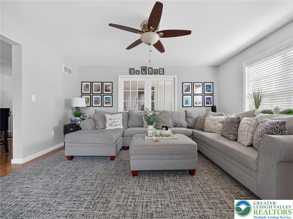 4148 Ross Road Bethlehem, PA 18020 - Photo 25 of 67 A welcoming family room features French doors, a ceiling fan, and abundant natural light.