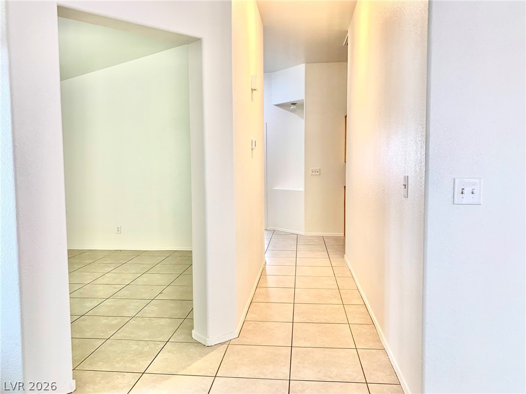 3821 Bombastic Court Las Vegas, NV 89147 - Photo 22 of 36 Hallway leading to inviting spaces with neutral flooring.