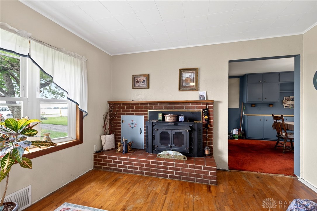 2470 Clark Run Road Xenia, OH 45385 - Photo 26 of 57 This inviting living space features warm wood floors and a charming brick fireplace.