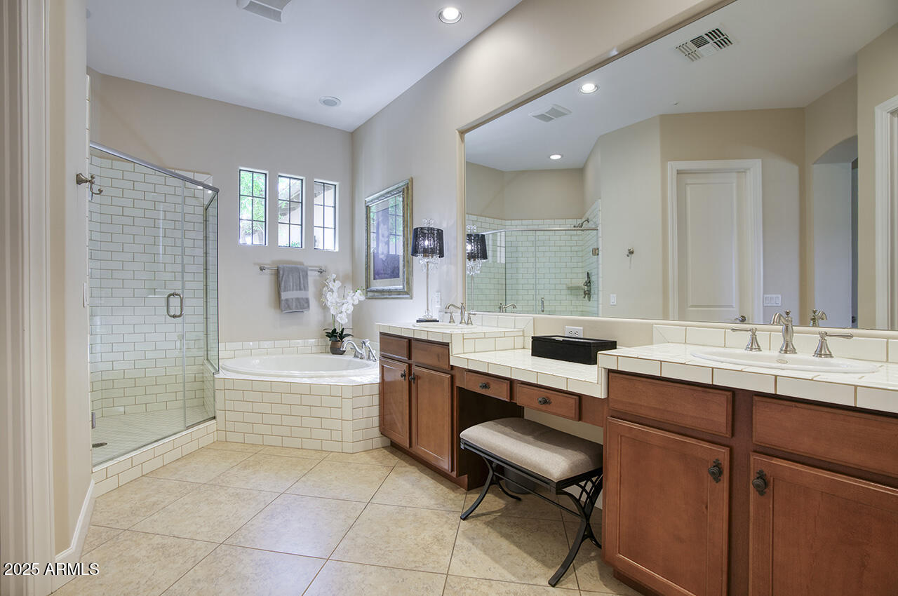 9190 East Hoverland Road Scottsdale, AZ 85255 - Photo 17 of 35 a bathroom with a sink double vanity granite tub shower and a mirror