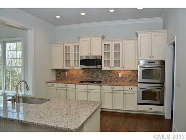 361 Olmstead Street Fort Mill, SC 29708 - Photo 3 of 16 a kitchen with stainless steel appliances granite countertop a stove a sink and a microwave