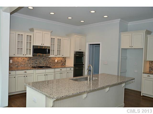 361 Olmstead Street Fort Mill, SC 29708 - Photo 4 of 16 a kitchen with kitchen island a counter top space appliances and cabinets