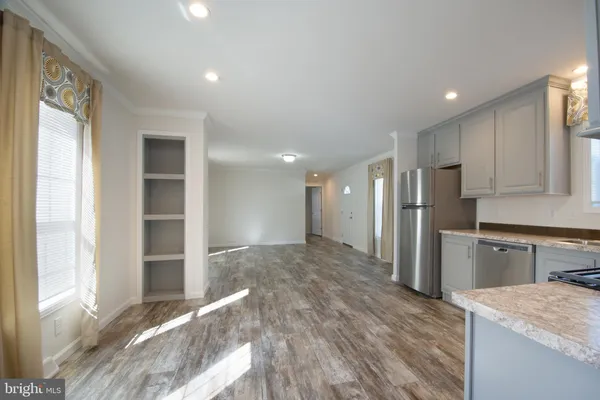 a kitchen with stainless steel appliances granite countertop a refrigerator and a sink