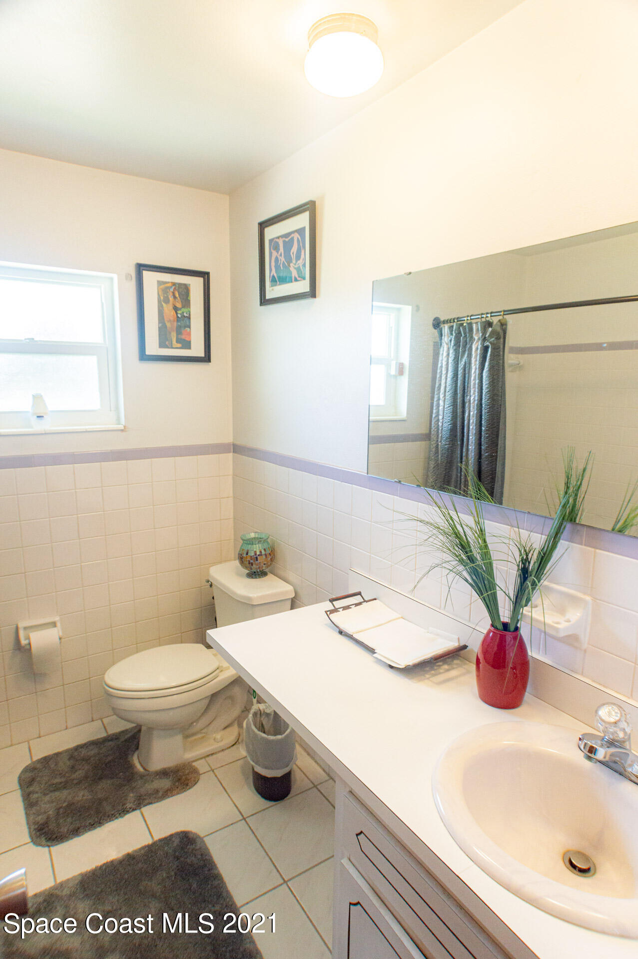 2435 Ricky Road Melbourne, FL 32935 - Photo 11 of 20 a bathroom with a sink a toilet and mirror