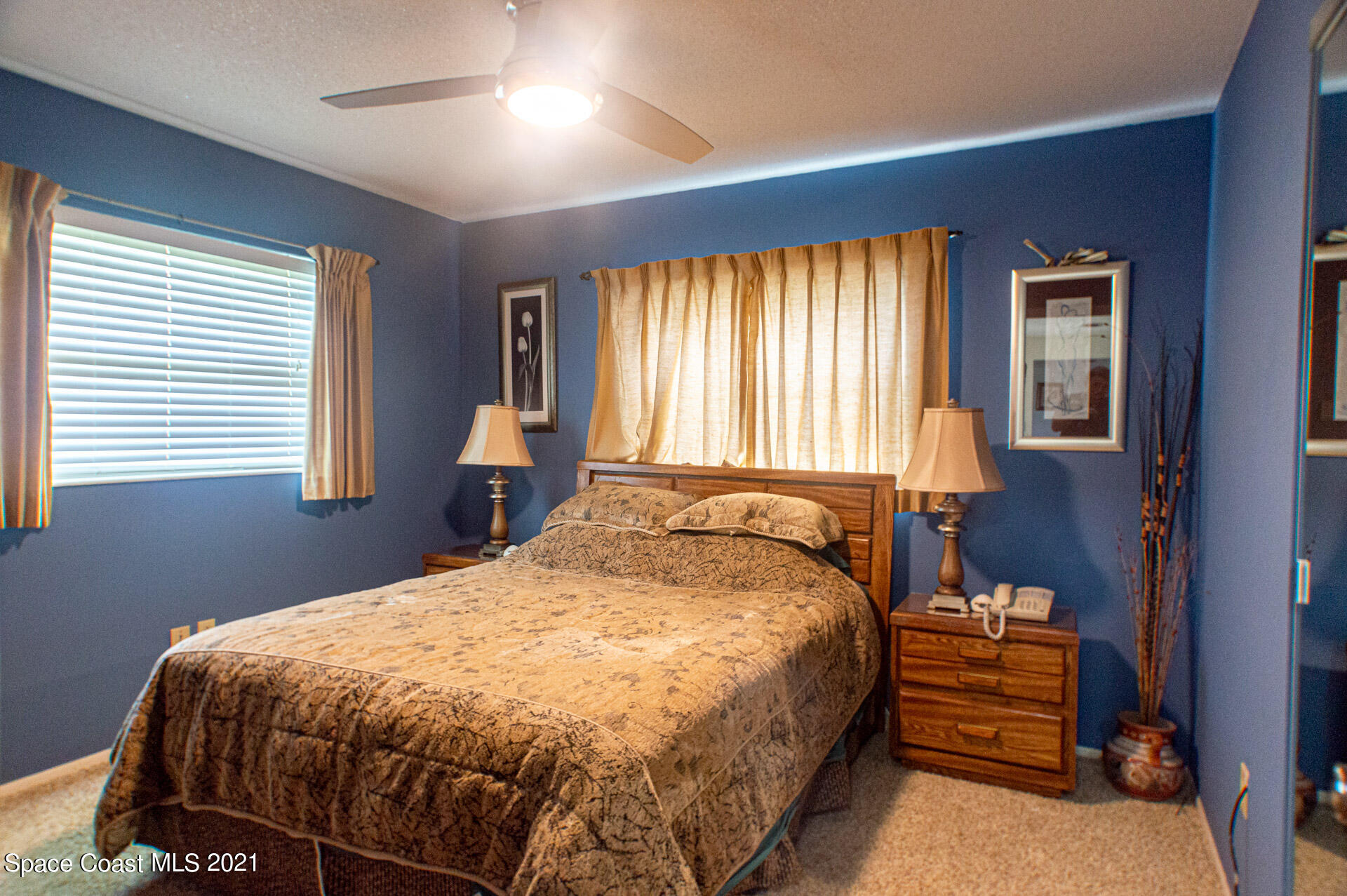 2435 Ricky Road Melbourne, FL 32935 - Photo 12 of 20 a bedroom with a bed and wooden floor